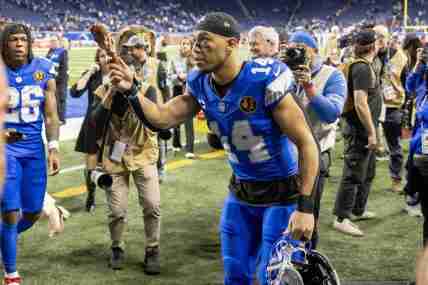 Nov 28, 2024; Detroit, Michigan, USA; Detroit Lions wide receiver Amon-Ra St. Brown (14) tosses a turkey leg to a fan after the annual Thanksgiving Day game defeating the Chicago Bears at Ford Field. Mandatory Credit: David Reginek-Imagn Images