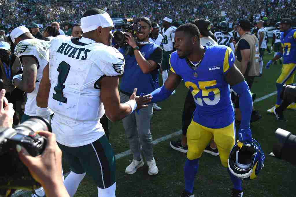 Sep 21, 2025; Philadelphia, Pennsylvania, USA; Philadelphia Eagles quarterback Jalen Hurts (1) and Los Angeles Rams cornerback Emmanuel Forbes (25) meet on the field after the game at Lincoln Financial Field. Mandatory Credit: Eric Hartline-Imagn Images