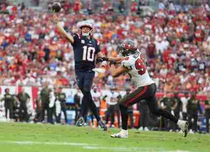Nov 9, 2025; Tampa, Florida, USA; New England Patriots quarterback Drake Maye (10) throws downfield under pressure from Tampa Bay Buccaneers linebacker Anthony Nelson (98) during the fourth quarter at Raymond James Stadium. Mandatory Credit: Nathan Ray Seebeck-Imagn Images